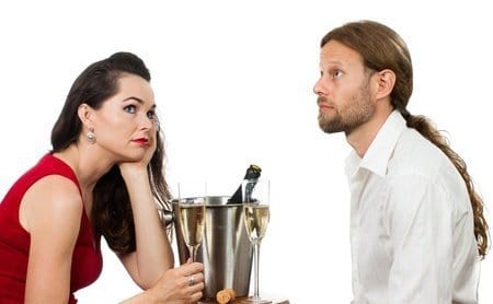 Bored couple drinking champagne